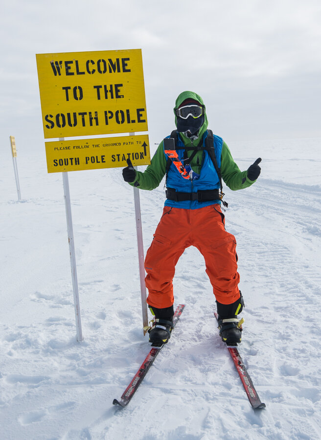 Thumbs up for reaching 'Welcome to the South Pole' sign